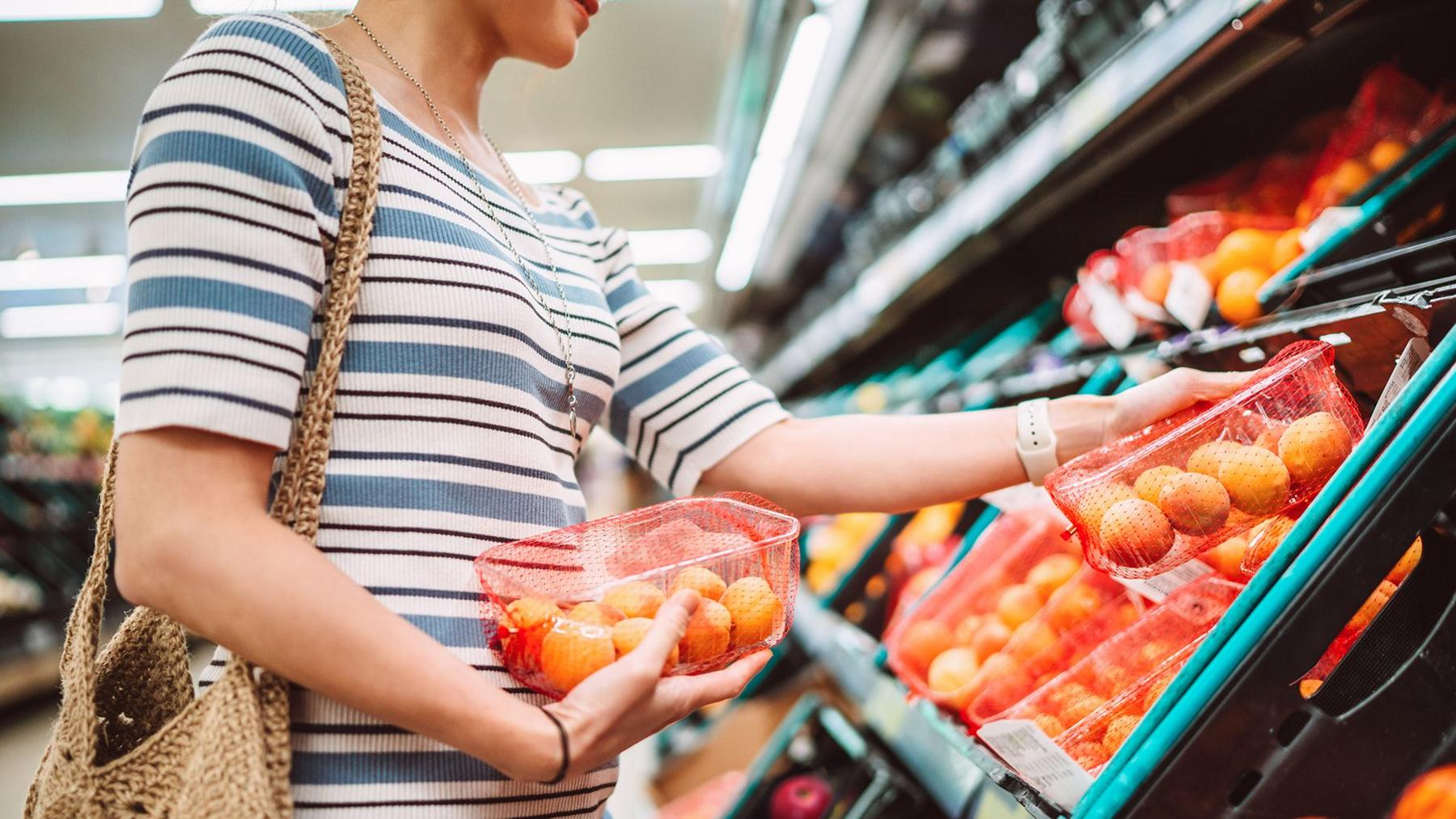 Indonesian family shopping at supermarket price increase